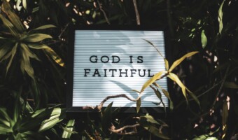 God is Faithful signage with leaved background